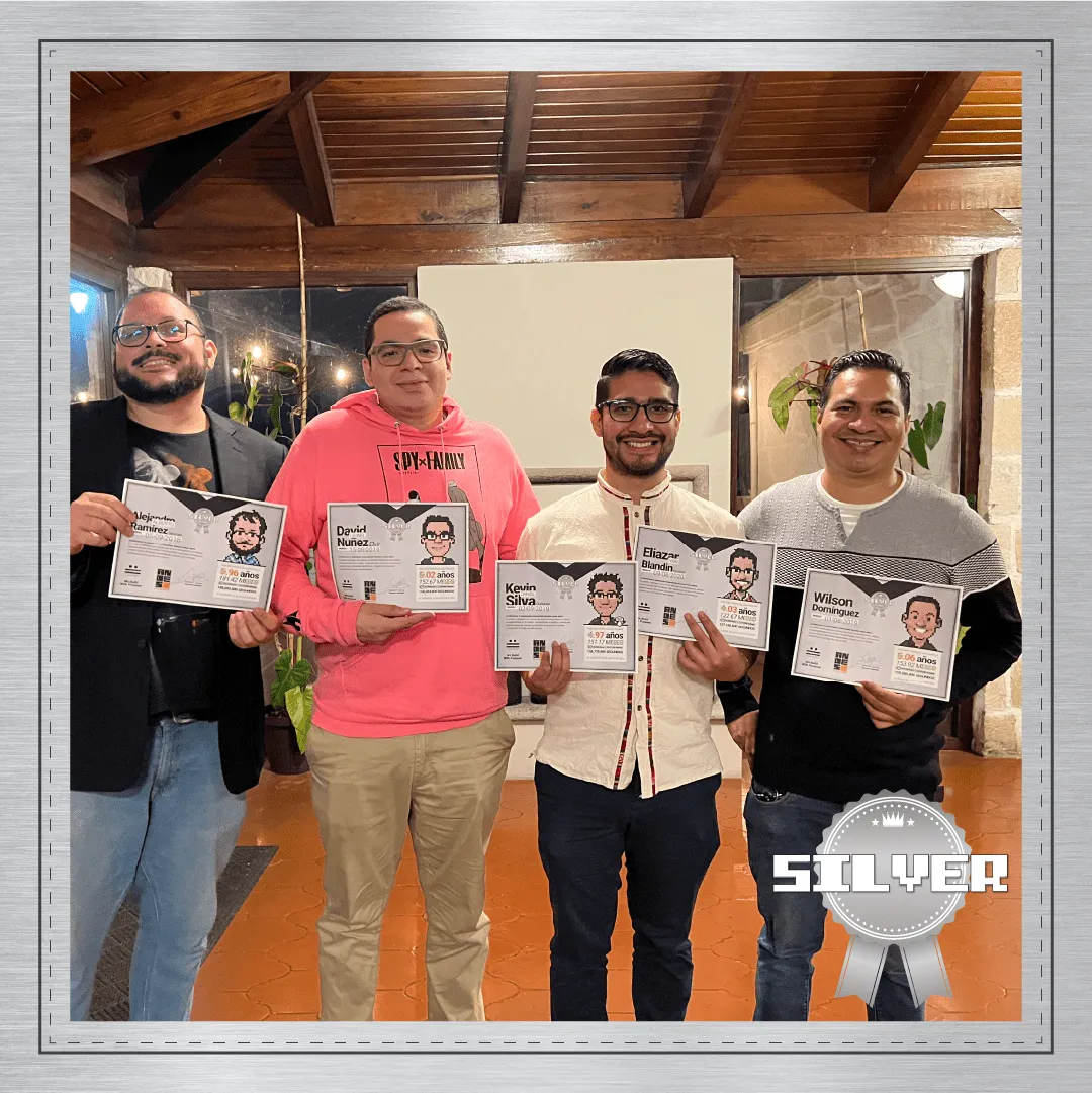 Group photo of the Silver Award recipients at Andes Development, recognizing 4 to 5 years of tenure at the agency. The technical and leadership team poses smiling with their pixel art avatar diplomas during the 12th anniversary celebration.