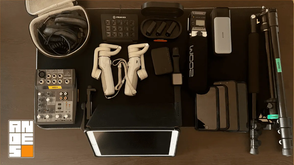 Complete mobile equipment kit used at Andes for marketing video production. The flatlay view details DJI stabilizers, Rode and Zoom microphones, a Behringer audio mixer, a Stream Deck, an Anker power bank, tripods, and multiple iPhone Pro devices. It represents the essential hardware recommended for mobile cinematic productions.